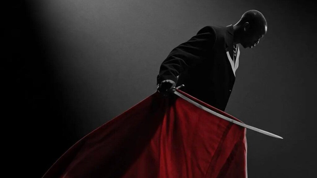 Visuel de l’album ZUKO! montrant Fireboy DML en cape rouge sous un projecteur