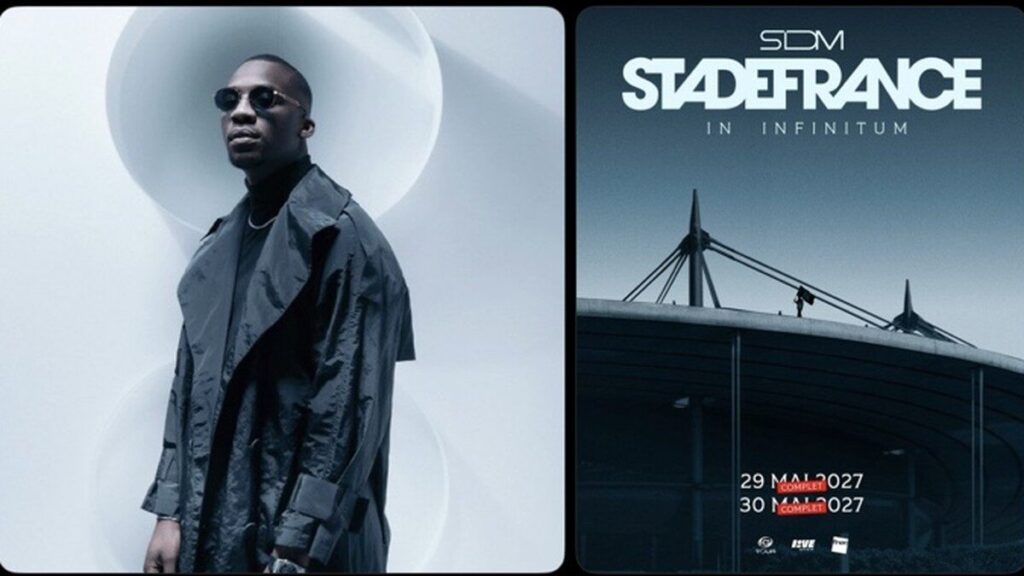 SDM à côté de l’affiche de ses concerts au Stade de France.